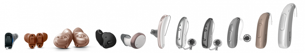 a line up of custom made in the ear and standard behind the ear hearing aids