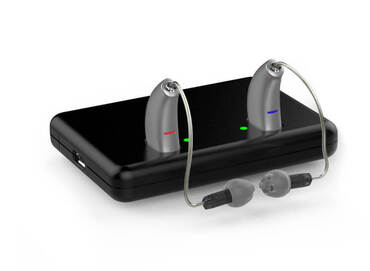 Bowers_Island_gray_behind-the-ear_hearing_aids_with_domes_and_black_charger
