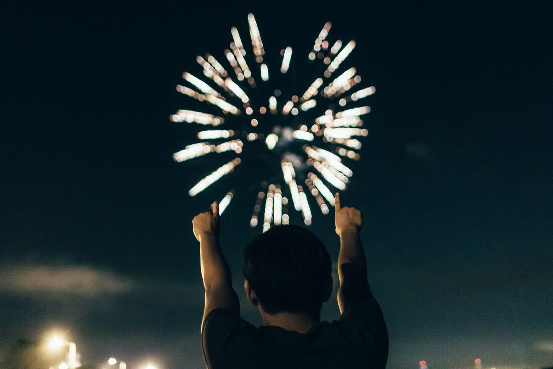 A young man experiences hearing loss while standing outside at night and pointing fingers in the air during a fireworks display in Northumberland.