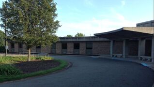 northumberland_hearing_center_millersburg_location_features_brick_building_with_curved_parking_lot_and_tree