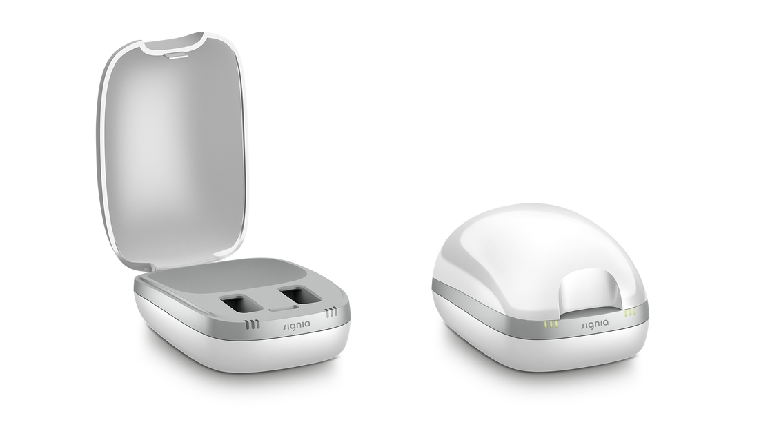 signia rechargeable hearing aids with a white and silver charger