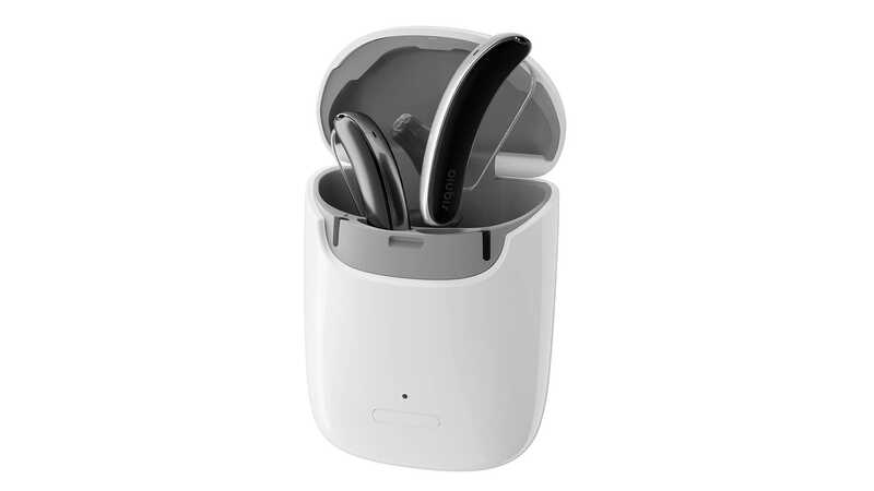silver and black behind-the-ear hearing aids in gray and white charger
